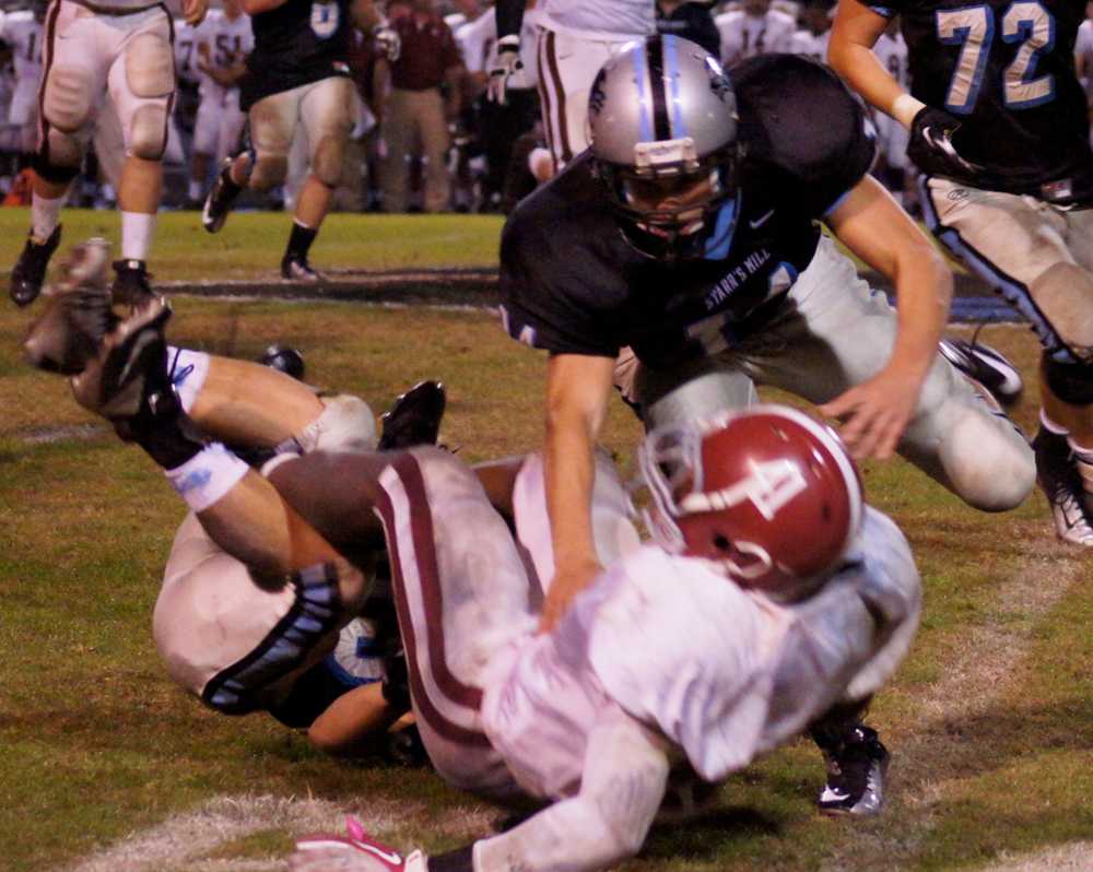 Freshman linebacker Luke Schoolcraft makes a big hit early in the third quarter. Defensive coordinator Dennis Bogumill said he feels that  Schoolcraft and fellow freshman safety Mitch Pattison "stepped up" to their varsity roles. 
