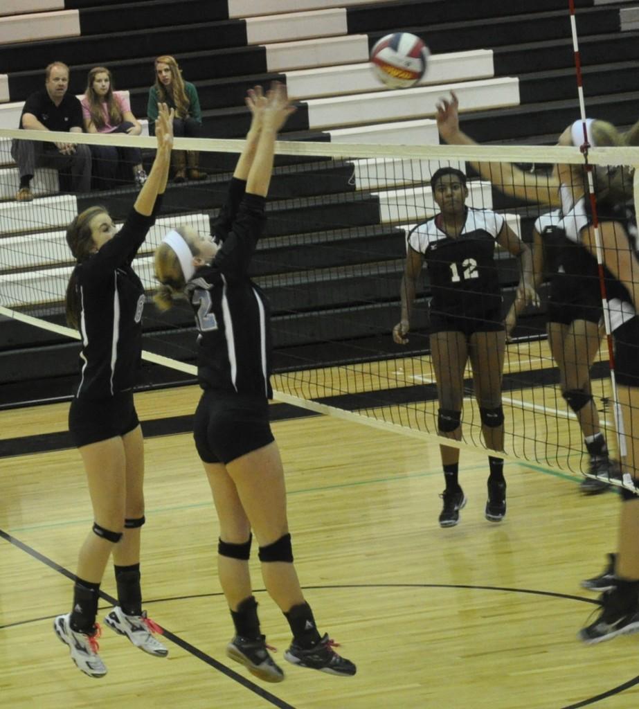 Middle blocker Jessie Schriver (far left) and right side setter Jenny Tomasello (left) try to block a McIntosh kill in their Final Four matchup Wednesday at McIntosh.  The Chiefs won in three sets.  Melissa Resler.