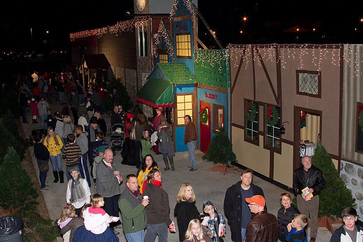 Vistitors view the sites and sounds of Dickens Villages 19th century English town. Cast members mix with the visitors to create a fun filled experience.