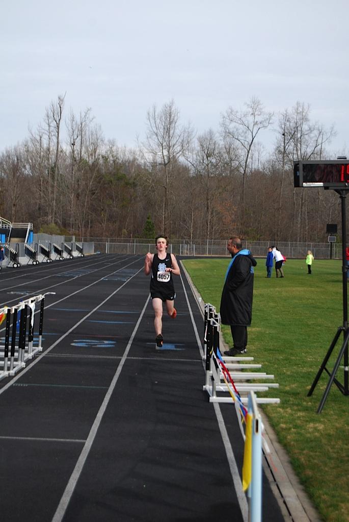 Sophomore Josh Warren is the first finisher in the mile relay, anchoring for team members senior Daniel Sims and freshman Reed Livingston. 