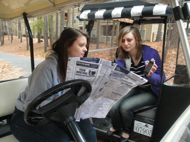 Sophomore Olivia Krug uses a friends iPhone to pull up the Peachtree City golf cart app so she can type in her destination. Within seconds she gets a map clearly marked with where she is and where she wants to go. Krug said the app is much less confusing than her paper map. 