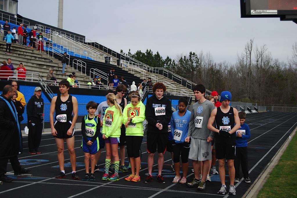 Athletes wait at the start line to begin the 3x1 mile relay.  
