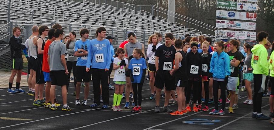 More than 100 runners take their places at the starting line waiting for the gun to go off for  the 5-kilometer race. 