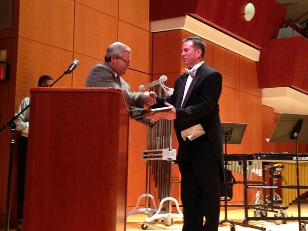 Band director Scott King accepts an award from the JanFest organizers for his Wind Ensembles performance at UGA Thursday night. 