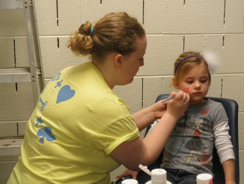 Katie Patterson paints a butterfly on the cheek of one of the children who attended the event. Patterson said she cant wait to volunteer for the Pancake Breakfast again next year. 