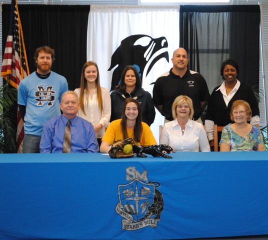 Senior Hailey Clark signs to play softball at Palm Beach State College, with her family and coaches there to watch. 
