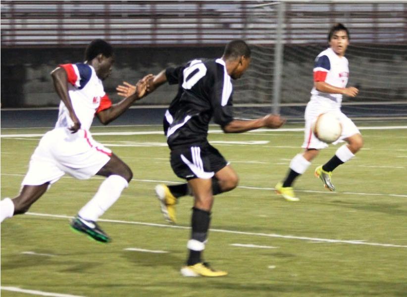 Sophomore Channing Park out runs a Harrison defender to the ball in the Panthers road loss on Feb. 15.
