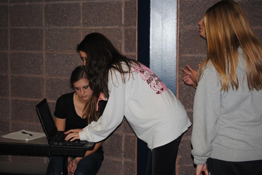 Yearbook staffer sophmore Jennifer Kurtz looks on while staffer junior Lynsey Sweatt enters her name after taking pictures with Close Up.