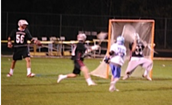 Junior Kyle Mitchell (right) scores one of the Panthers 16 goals in their win against Whitewater on March 12.