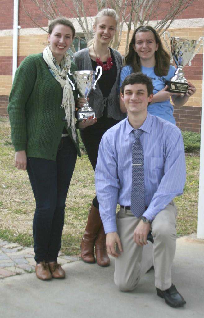 Sophomore Lexi Nails (right) finished as runner-up for Lincoln Douglas at the varsity state tournament, while senior Georgia Brunner (left) and her partner Annefloor De Groot (middle) placed in the top four for public forum, losing in their semifinal round.  Brandon Kendall (bottom) is the debate coach, and Sean Hickey (not pictured) is the speech coach.