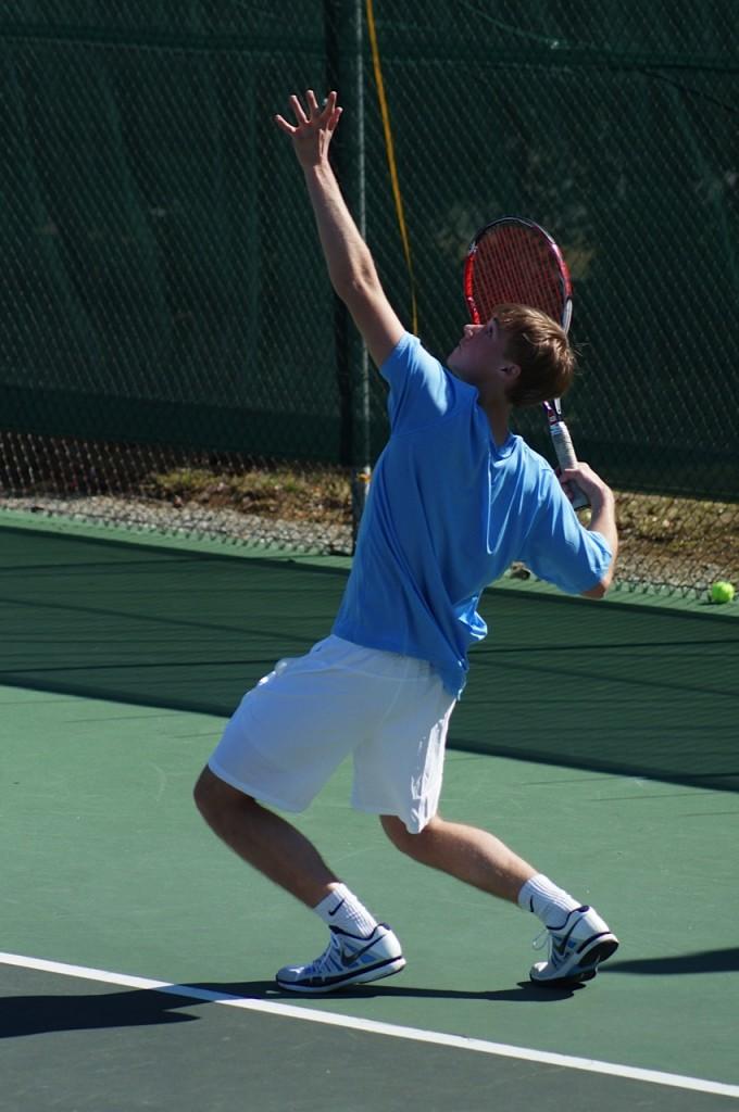 Senior Frank Rogers serves the ball to the opposing team at the regional game