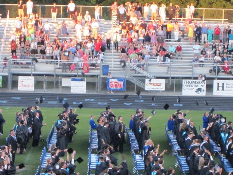 As the 2013 class song began to play at the end of the ceremony, the graduates threw their caps into the air.  