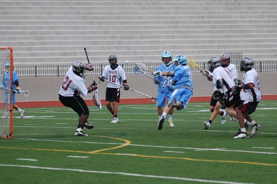 Senior Kyle Smith (8) scores a contested goal in the Panthers 21-2 win against Grady Wednesday night in their last game of the season. 