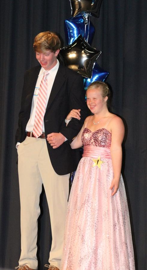 Participant #1 senior Alex Goodman is escorted on stage by her brother, Adam, at the start of the pageant.