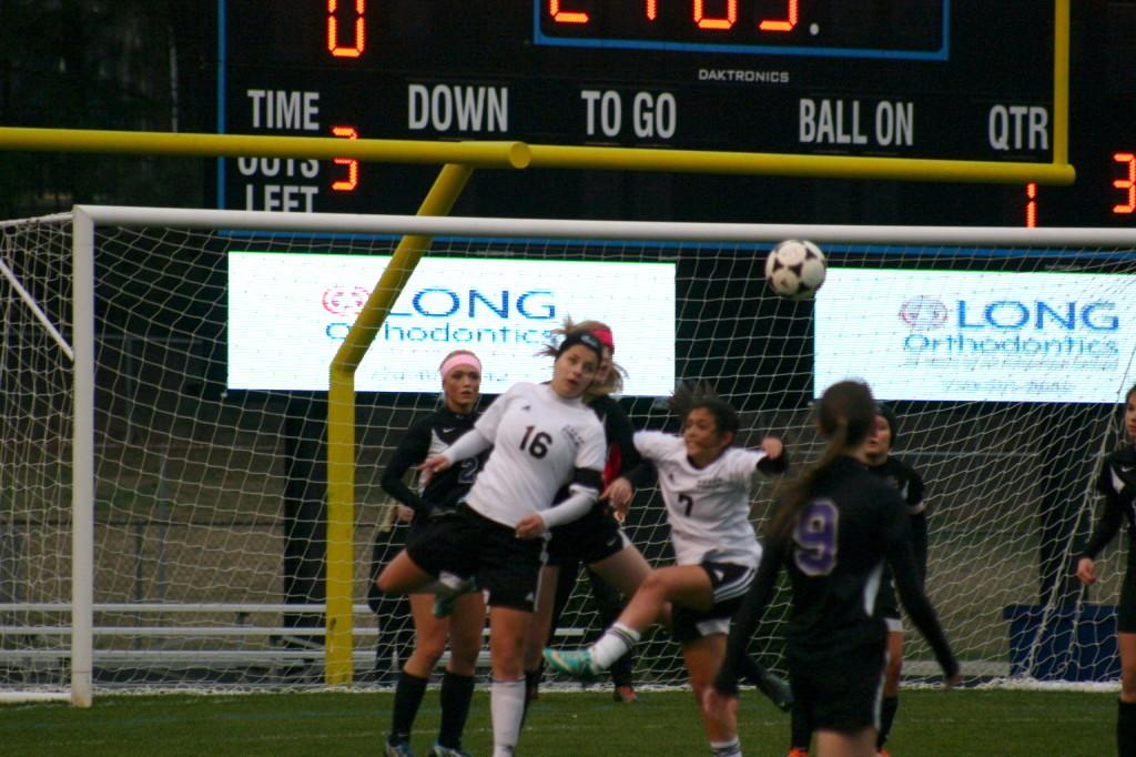 Junior Jenna Currin, one of  four Lady Panthers selected for the DiVarsity All-Star game, heads the ball away from defenders in SMHS's 3-1 loss to Whitewater that  ended their playoff run. 