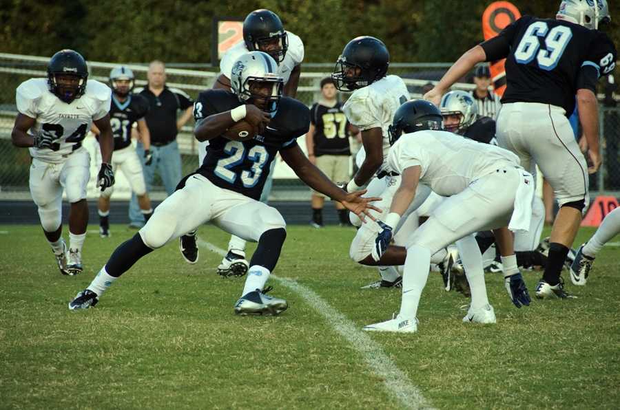 Senior John Smith (23), in his first home game after breaking his femur last season, rushed 21 times for 122 yards and one touchdown. 