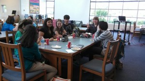Sophomores Andrea Rathje and Regan Romuno enjoy snacks and socialize with the others at their table as they decide which books to read for the month.