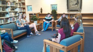Lela Crowder (middle right), a book club sponsor, and Ex Libris members discuss the three book selections after the officers' presentation. 