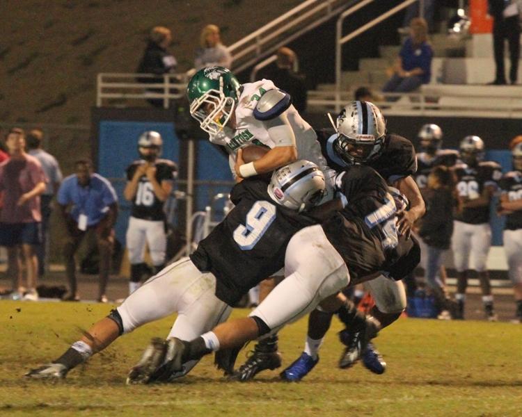 Sophomore Melvin Broomfield (9) and junior Luke Schoolcraft (14) make a tackle to stop the Chiefs from getting a first down and extending their drive. 