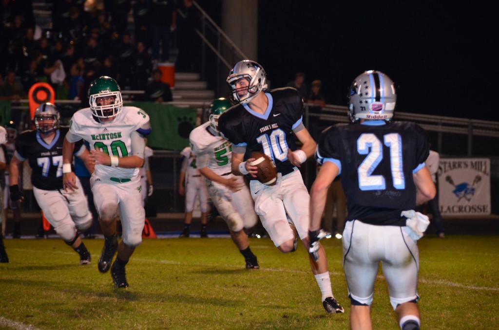 Senior quarterback Kyle Moseley tries to evade the McIntosh defense. Moseley went 15-for-22 with 216 yards and 2 touchdowns in the come-from-behind win against McIntosh, 42-27.