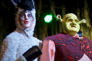 Seniors Taylor Rowell (left) and Ethan Hatcher (right) stare out into a sold-out crowd as they begin their journey to save Princess Fiona, played by junior Camille Edwards, from a fierce, fire-breathing dragon, junior Abby Feltner. 