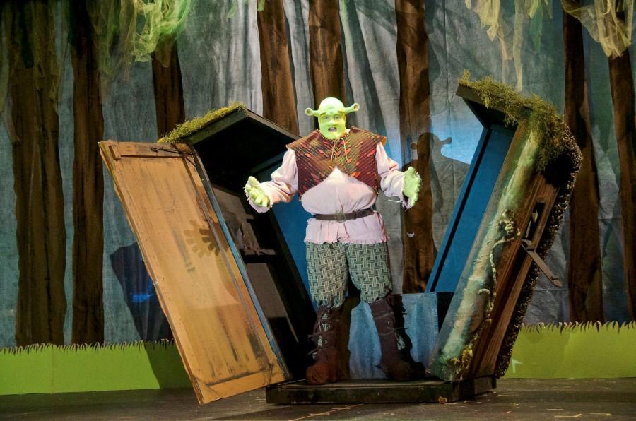 Senior Ethan Hatcher makes his grand entrance as Shrek at the beginning of the play by bursting out of a little shack and singing Bright Beautiful World as he admires his swampy home.