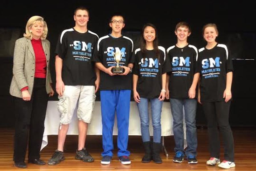 Junior Tom Zhao triumphantly holds his teams second-place trophy from the Griffin RESA Regional 2014 Math Contest. His teammates are seniors (from left) Austin Palmer, Vivian Nguyen, Ricky Macke, and Morgan Stephens.
