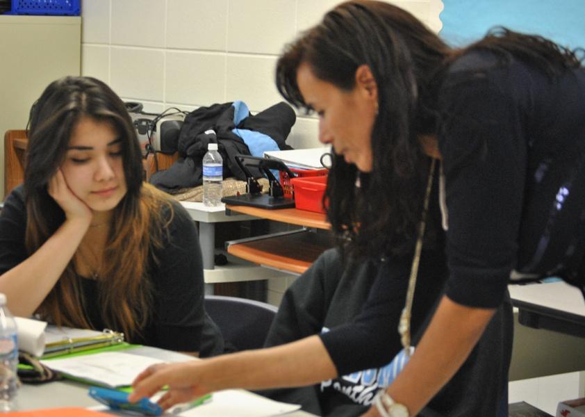 Aziza Simmons (right), who was selected for a trip to Japan by the International Educators to Japan Program, helps her students in her English to Speakers of Other Languages class.