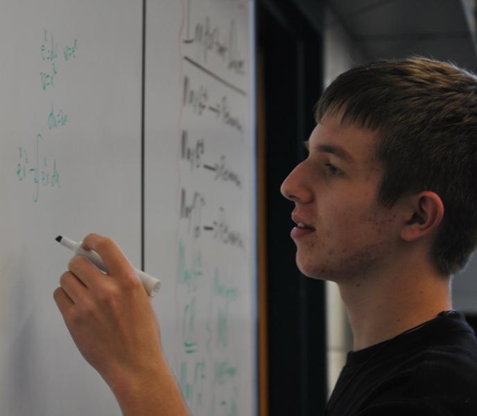 Ricky Macke, SELECTED TO ATTEND the Governors Honor Program for math, works on a calculus problem during instructional focus.