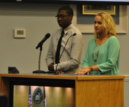 Junior Tessa Strickland and Whitewater junior Khalil Coleman present their proposal to create safer golf cart paths to the south complex as part of the Fayette County internship on Aug. 14 at the Board of Commissioners meeting.