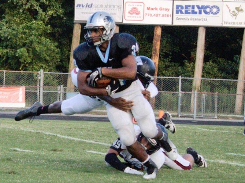 Freshman running back Rico Frye (34) breaks the tackle of a Whitewater defender in the Panthers home opener. Frye ran for 83 yards on 13 carries and two touchdowns.