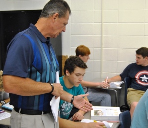  History teacher Jon Gloer helps junior Alex Rivera with an American Revolution chart.  Gloer returned to Starrs Mill after retiring in May 2013. He teaches three periods a day. 