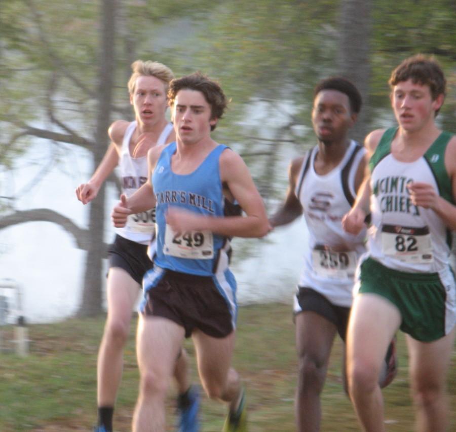 Top runner for the boys team, Josh Warren,  sprints his way to victory at the Region meet. 
