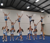 The varsity cheerleaders enjoy the freedom and the open space as they practice their routine for state finals in their new facility.