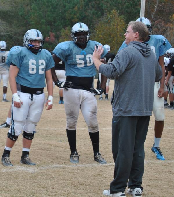 Offensive-line coach Frank Maguire shows how to block effectively in preparation for Friday nights playoff game against Ware County