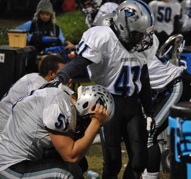 Senior defensive end Cory Carter (51) receives a comforting pat from senior teammate Ashton Blackmon (41) in the closing moments of the Panthers 45-10 loss to Ware County. 