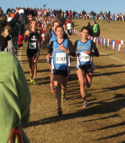 Senior Emily Sims (left) runs next to junior Sophie Handel in the first lap at the state meet. Behind Sims is junior Sarah Phinney. They would then go on to finish in the top 25. Phinney placed 21st, Sims placed 22nd, and Handel placed 18th at the state meet.