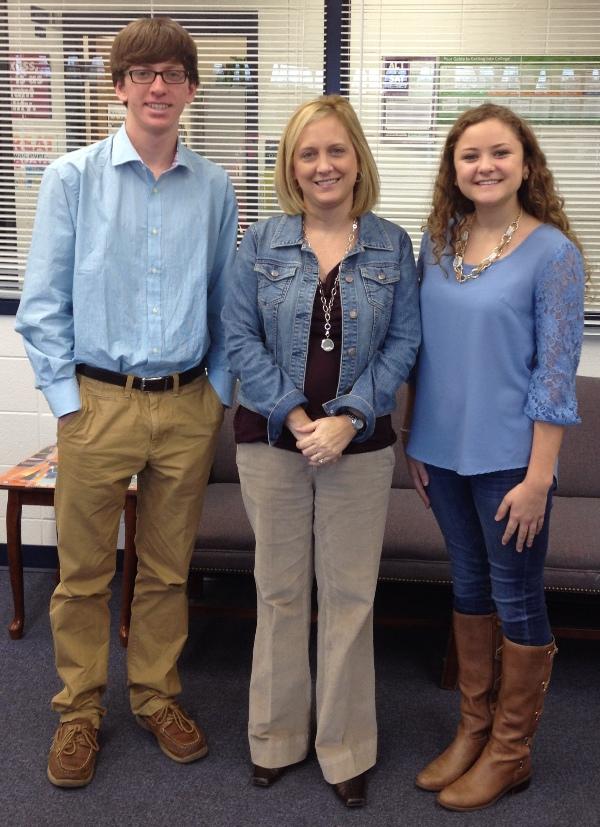 Guidance counselor Connie Patterson wishes the semifinalists  seniors Emma Wernecke and Kevin Hilinski good luck in their application process in pursuit of a National Merit Scholar.