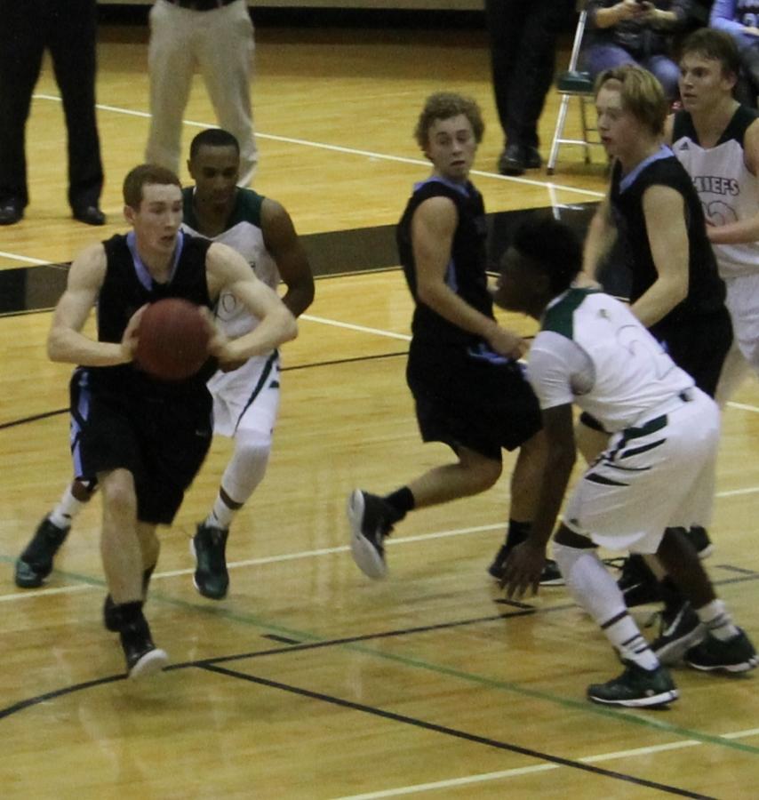 Senior forward Eric Sutliff passes the ball in the game against McIntosh. Sutliff tallied four points and seven rebounds.