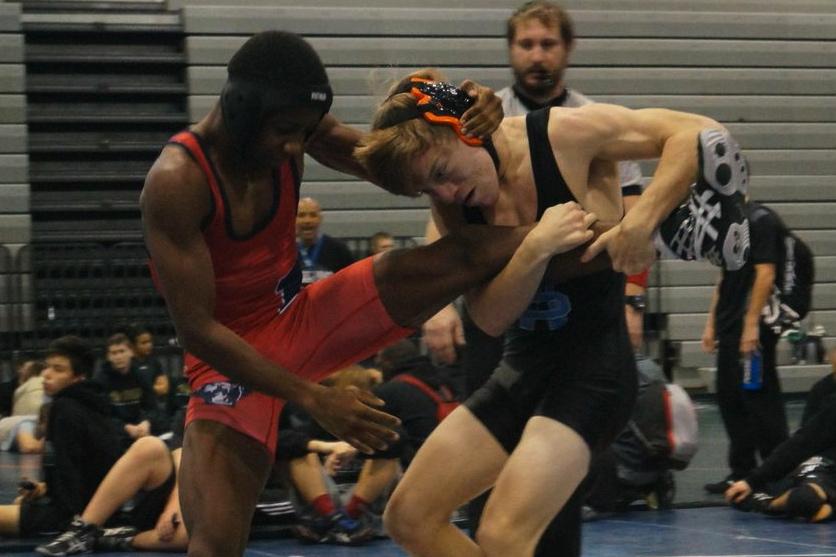 Senior Jonathan Parrish (right) attempts to bring his opponent from Dunwoody to the ground at the meet on Nov. 22 at Kennesaw Mountain. 