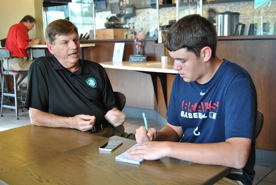 Sports editor junior Jack Fletcher interviews Gary Phillips (left), the new executive director for the Georgia High School Association. The former Fayette County High School principal was also Herschel Walkers high school football coach at Johnson County High School.