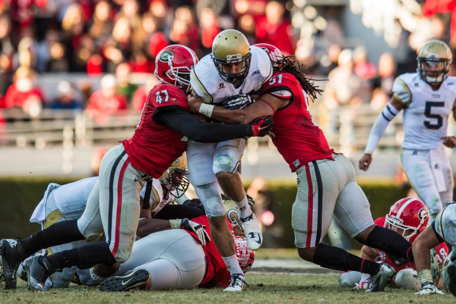 Georgia Tech running back Zach Laskey (37) runs through two defenders in a game at Samford Stadium. He ran for 140 yards and three touchdowns in the 30-24 win. 