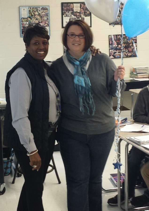 Principal Audrey Toney surprises Emily Willis with a bunch of blue and black balloons and the news that she is the 2014-2015 SMHS Teacher of Year. 