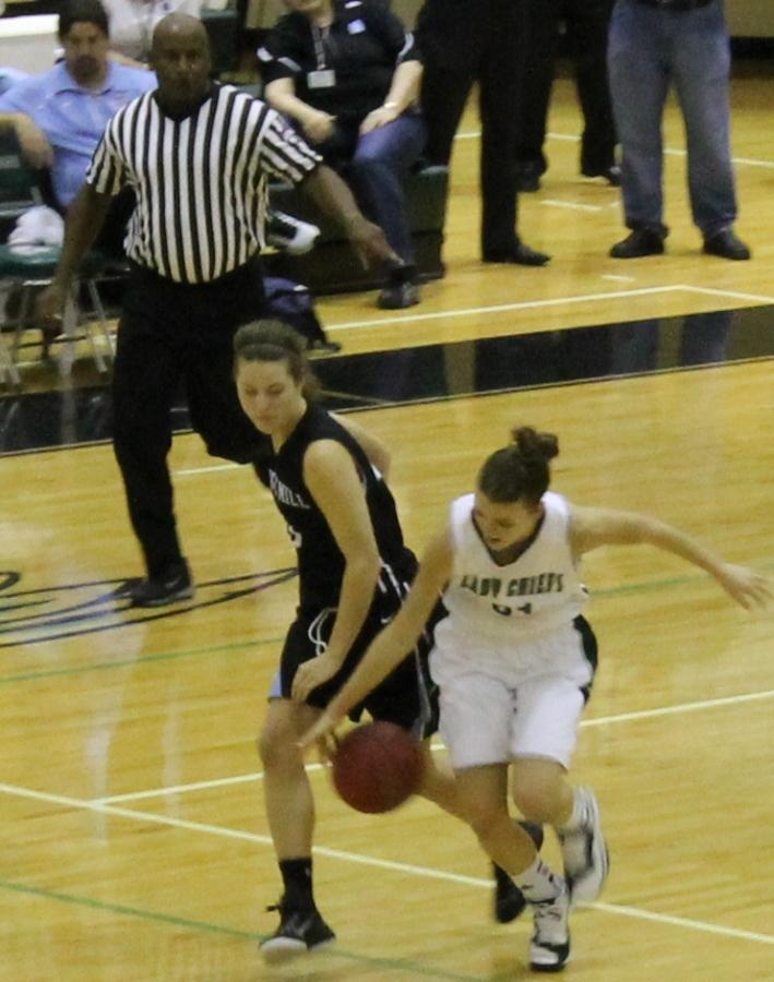 Senior Carly Pressgrove fights for the ball in the game against McIntosh. She finished with two points, three rebounds, and a steal.