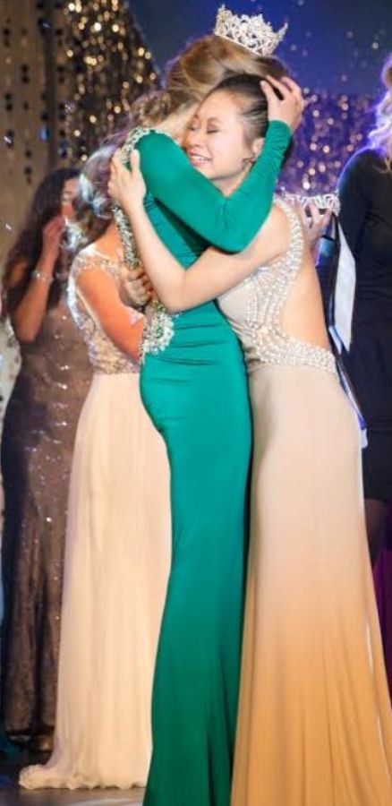 Senior Abby Feltner (left), last years Miss Starrs Mill, embraces sophomore Yuri-Grace Ohashi after her name is called.