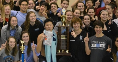 The swim team gathers around their 15th county trophy after the Jan. 16 championship meet at the Summit YMCA in Newnan. 