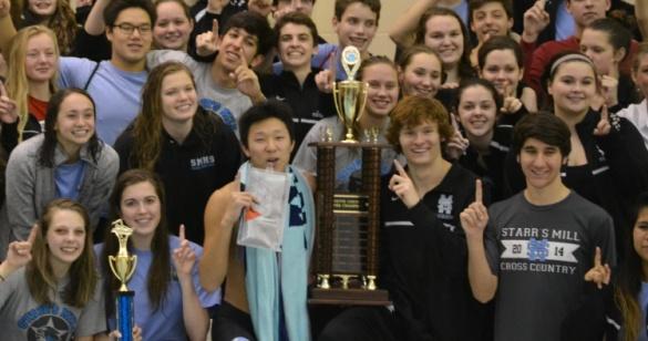 The+swim+team+gathers+around+their+15th+county+trophy+after+the+Jan.+16+championship+meet+at+the+Summit+YMCA+in+Newnan.+