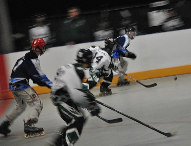 Freshman Mitchell Prowant skates down the rink, battling against the Panthers' rival the Chiefs so he may have the chance to score and tie up the game.