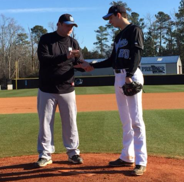 JV baseball coach Walt Ellison gives sophomore pitcher Jordan Hall pointers during a recent practice on how to grip the ball properly.