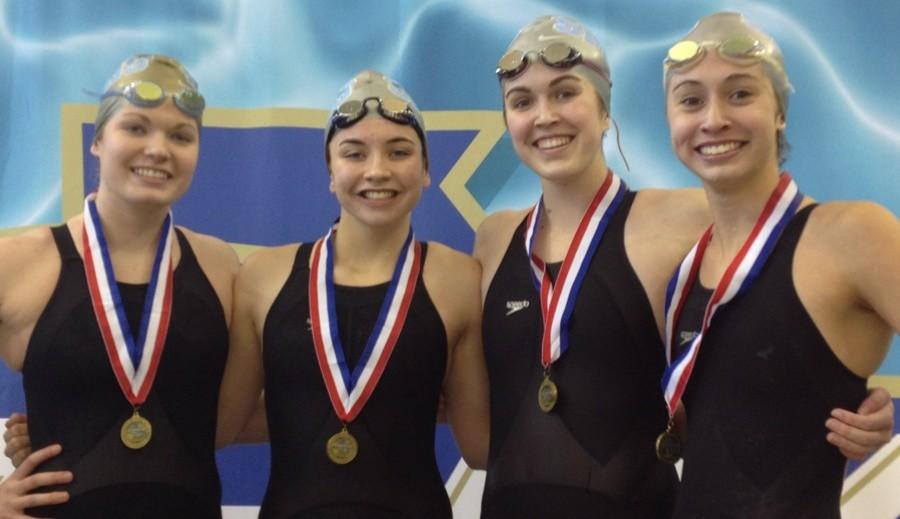 Sophomore Donna Blaum (from left), freshman Kylee Bogumill, junior Sarah Phinney and senior Johanna Goldblatt proudly wear their gold medals after breaking the womens 400 yard freestyle relay record at the state meet on Feb. 7. 